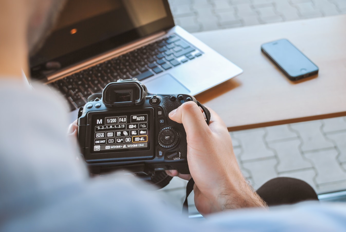 person holding DLSR camera