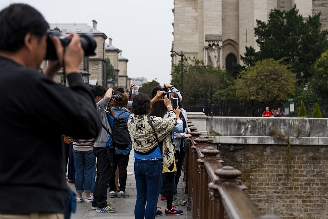 people taking photo of Paris architecture