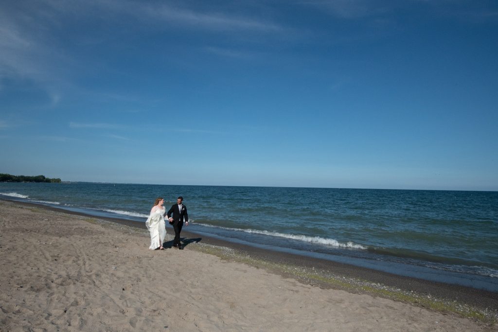 newlyweds walking together on the beac